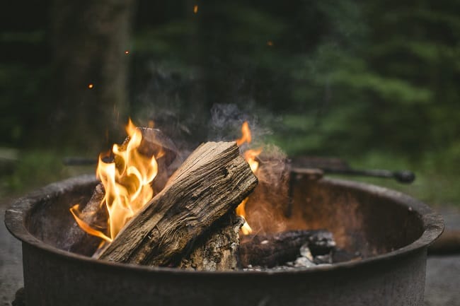 Tin DIY fire pit with burning coals and wood