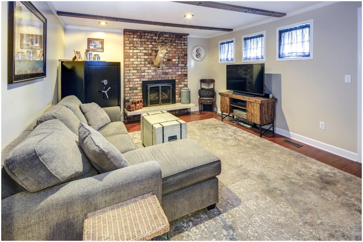 warm basement living room with fireplace