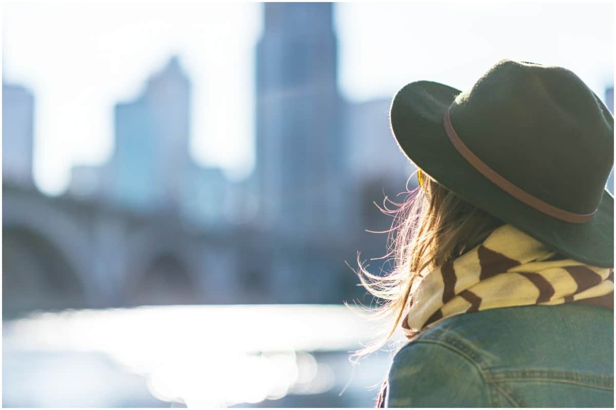 girl wearing hat looking out into new walkable city 