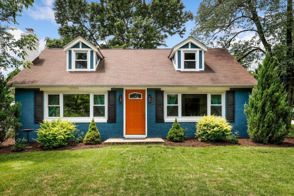 blue-house-front-yard-with-white-trim-orange-door