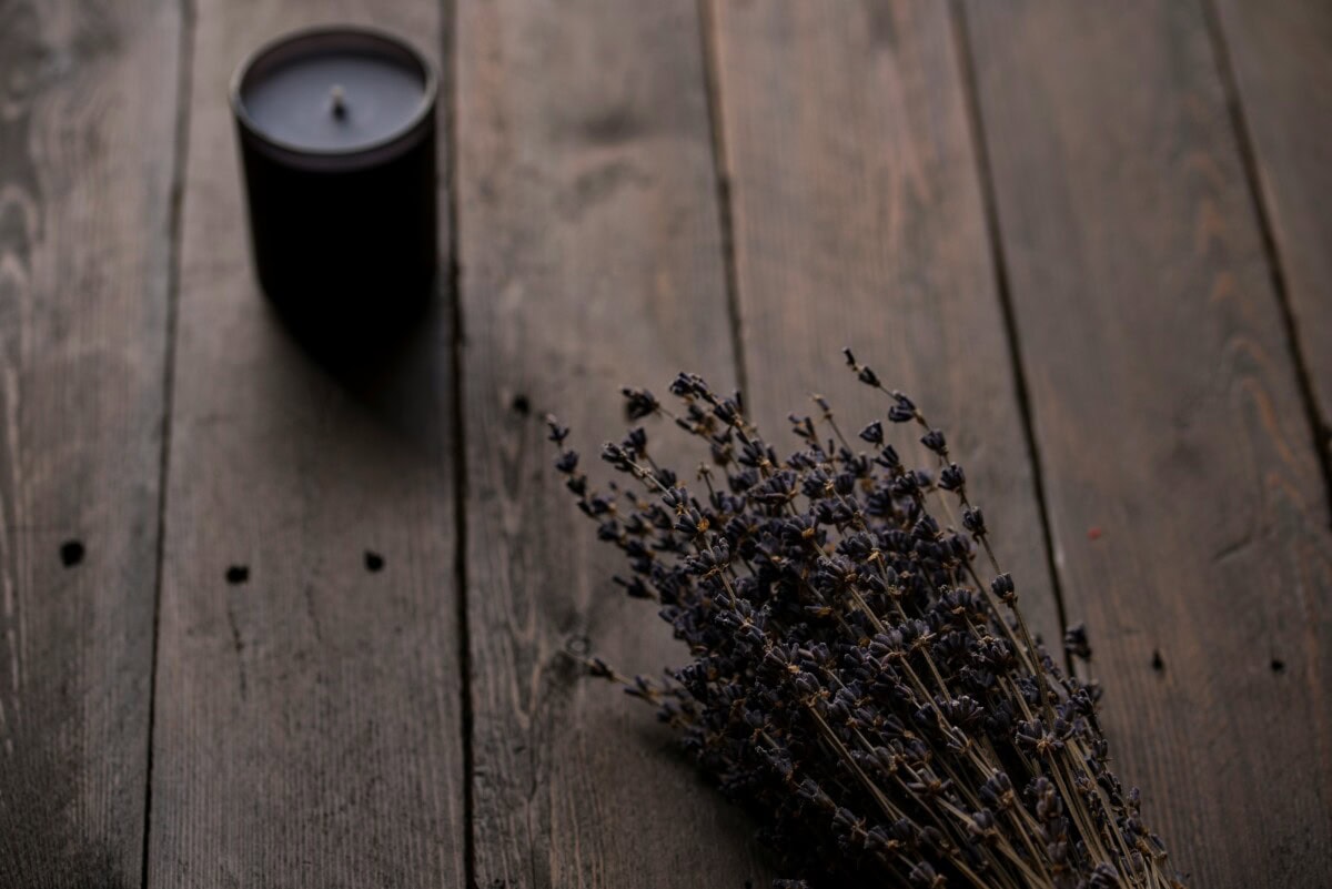 black candle and dried flowers