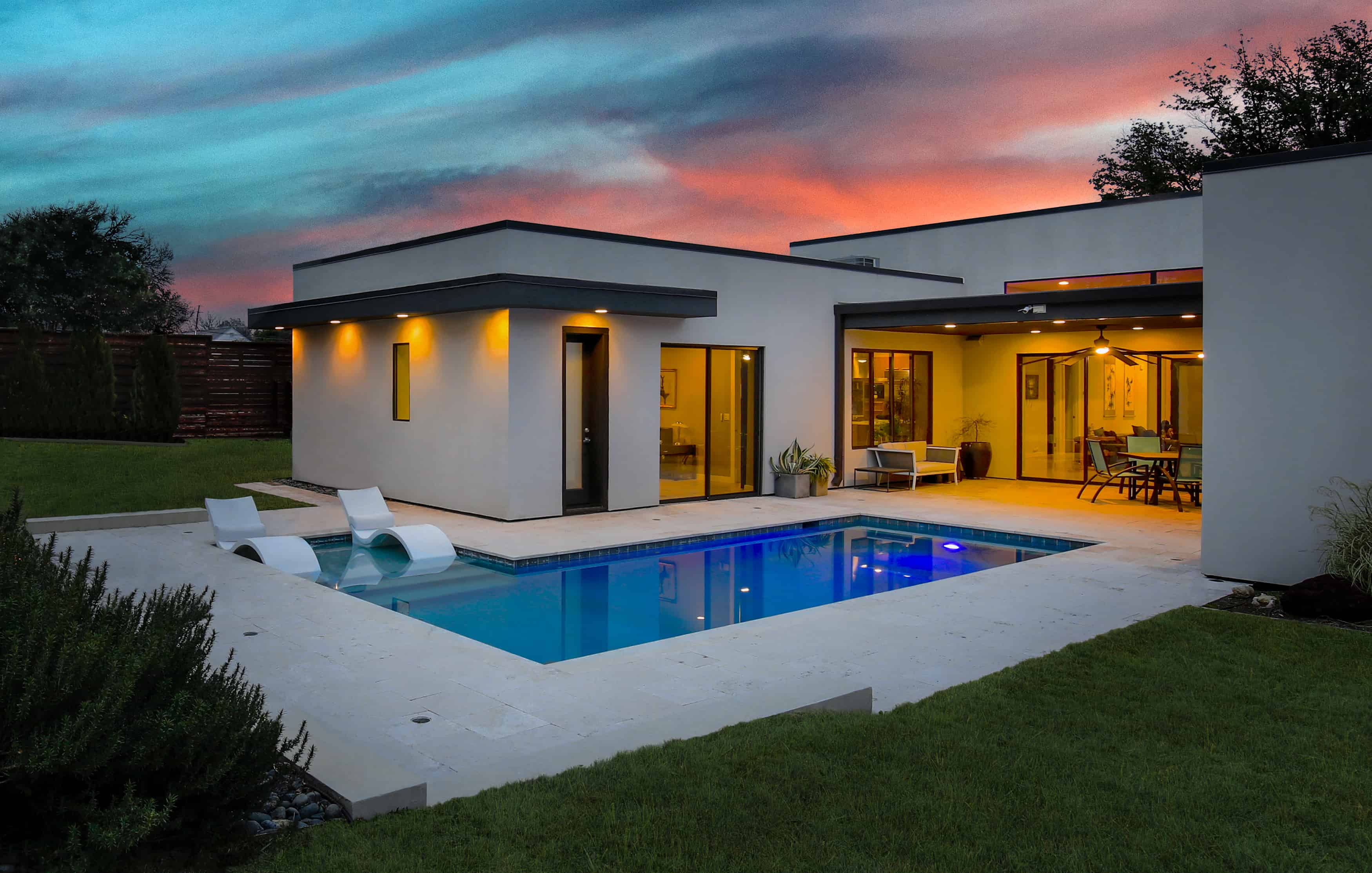 Modern home exterior with backyard pool and open concept