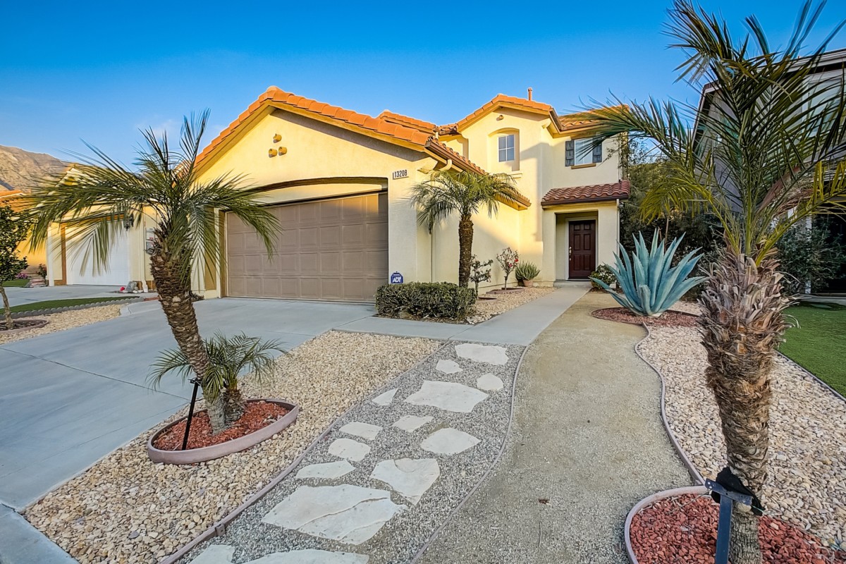 Home in San Diego with rock path, palm trees, and stucco siding