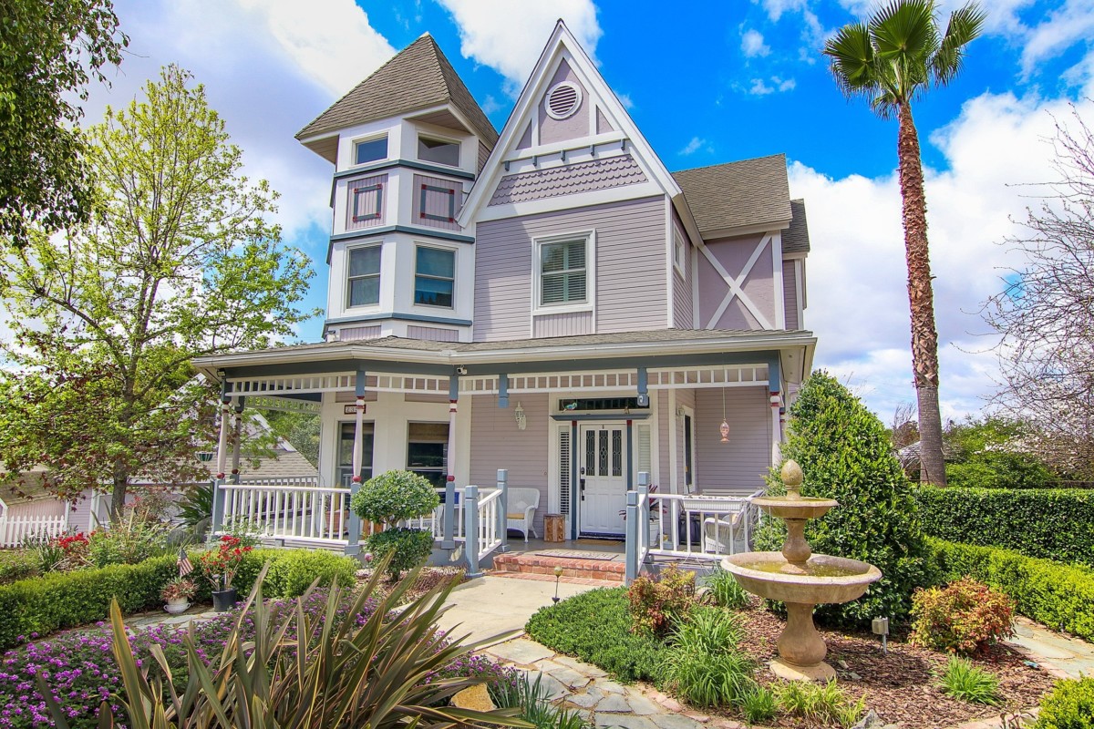 stick-eastlake victorian style home with notable stick detailing and pathway to the front door