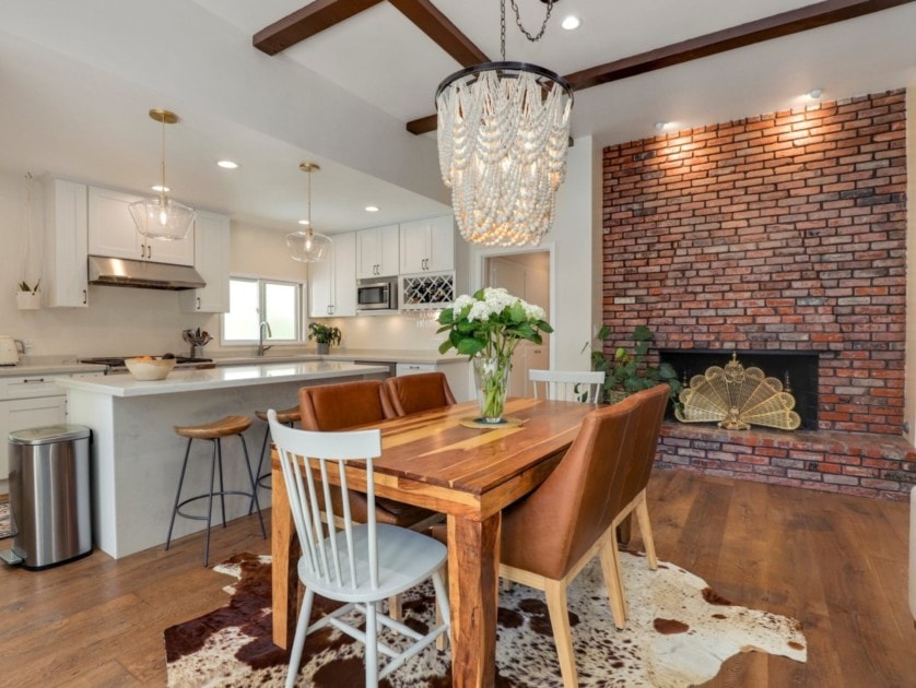 Dining room with unique chandelier and brick fireplace