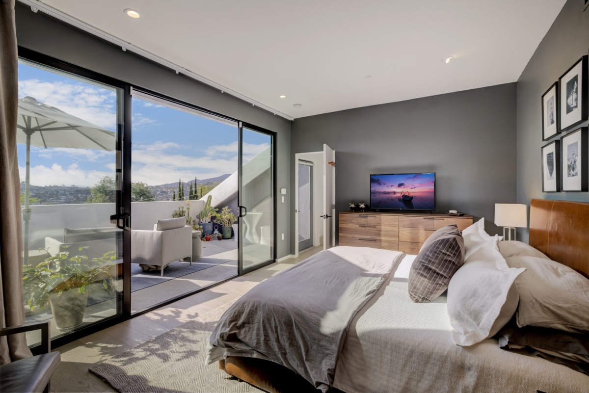 bedroom with sliding glass doors lots of natural light