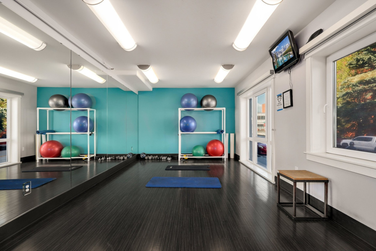 Apartment complex gym amenity with yoga mats and exercise balls