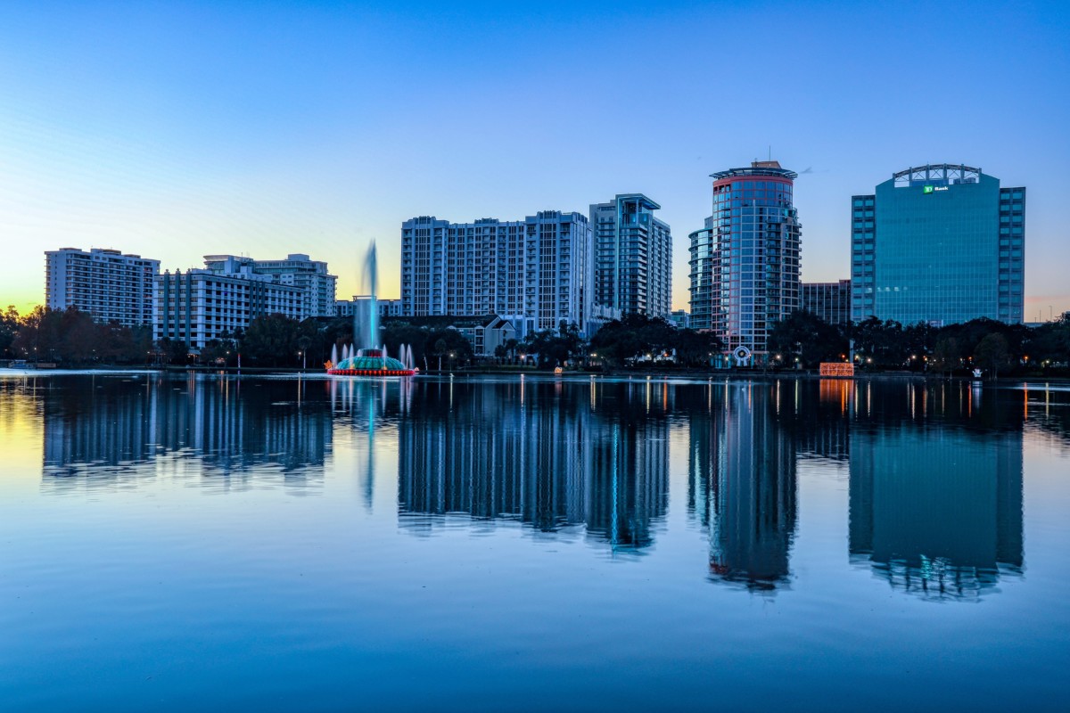 view of Orlando skyline from a body of water at dusk