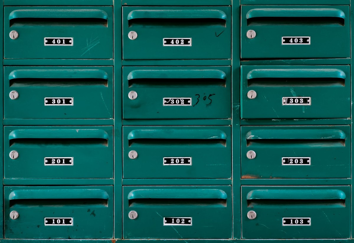 green apartment mailboxes with apartment numbers