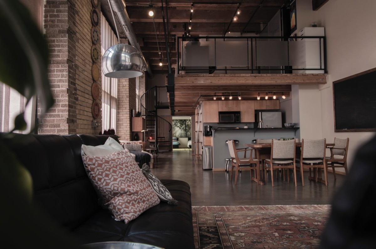 open-concept living room, kitchen, and dining room in industrial loft