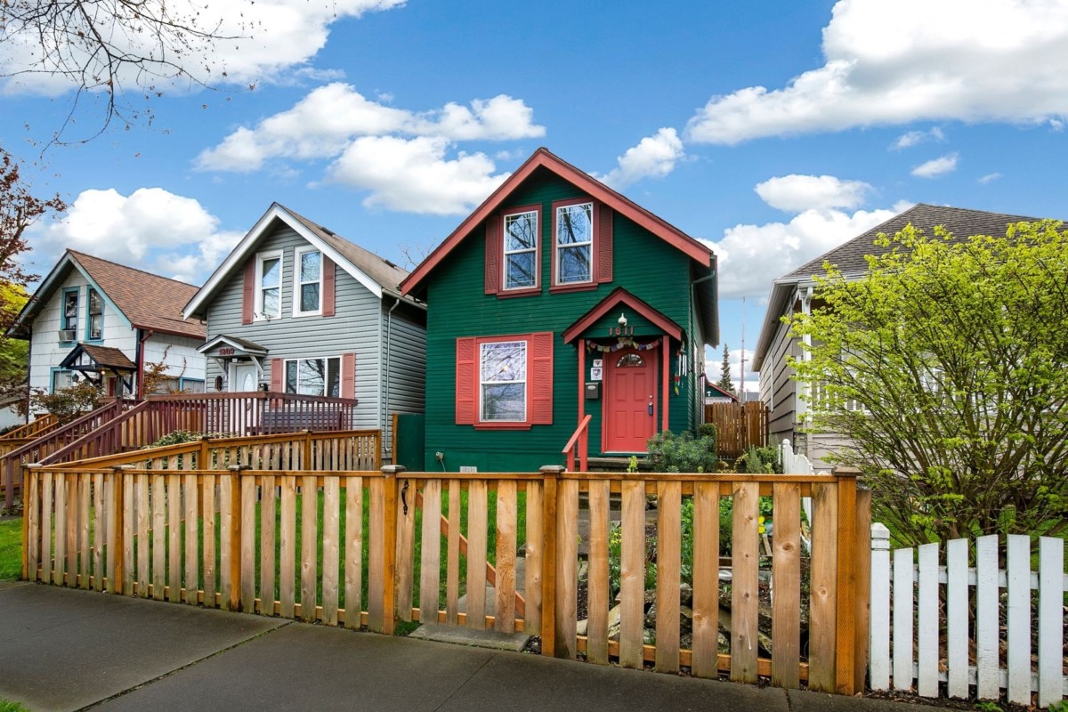 two-story rental home with wooden fence