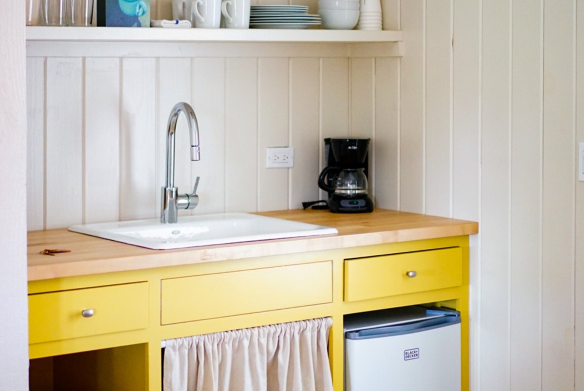kitchenette with yellow cabinets