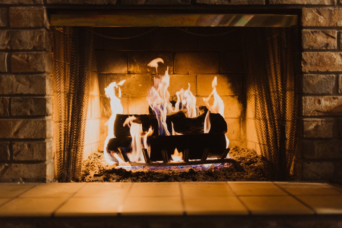 wood burning fireplace that's lit