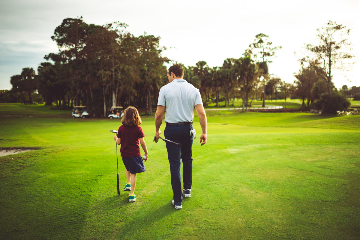 A father and daughter golfing