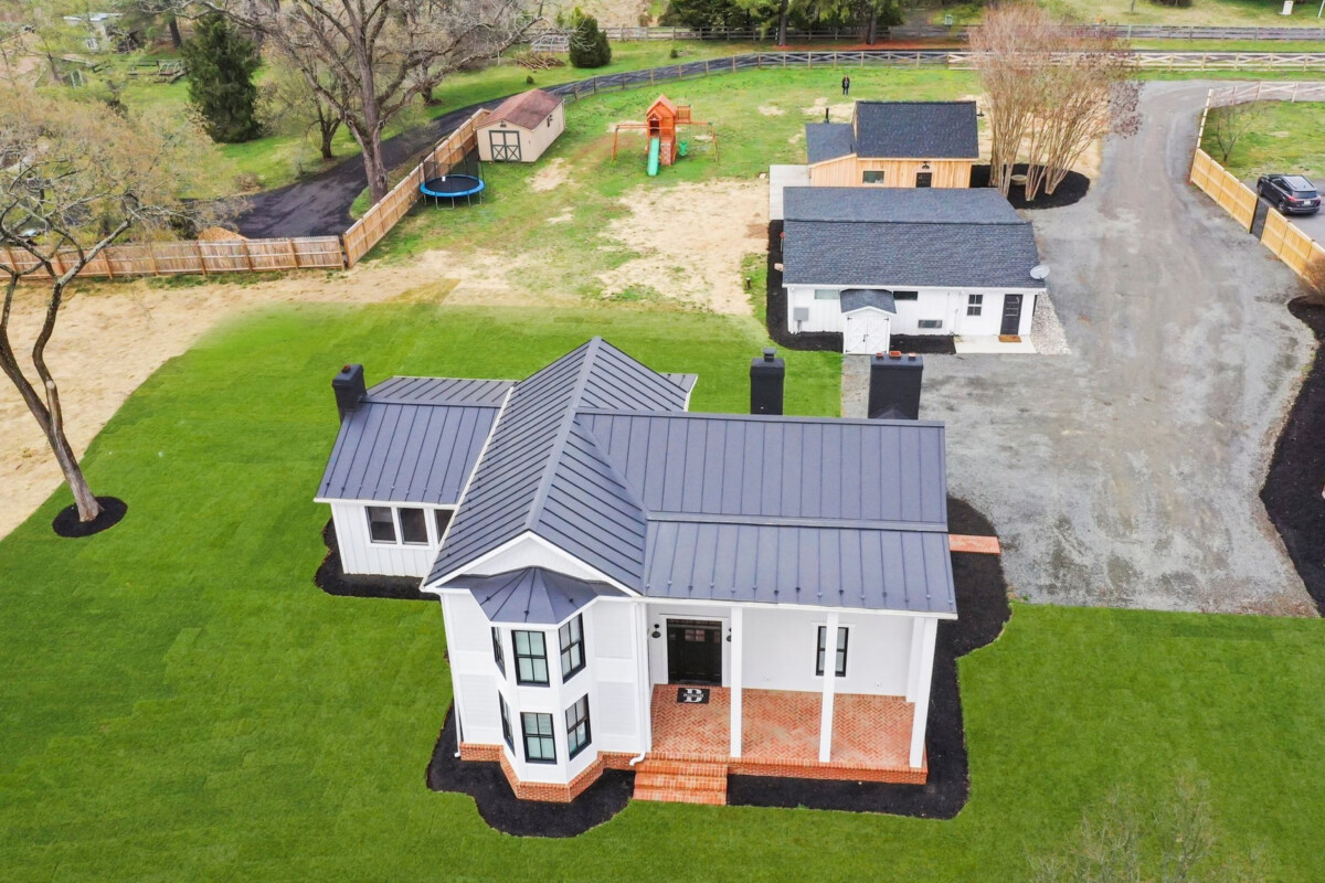 aerial view of modern farmhouse with detached garage